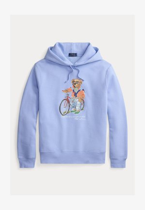 Felpa con cappuccio azzurro chiaro con grafica di un orso in bicicletta, che indossa un abito colorato. Tessuto morbido e coulisse regolabile.