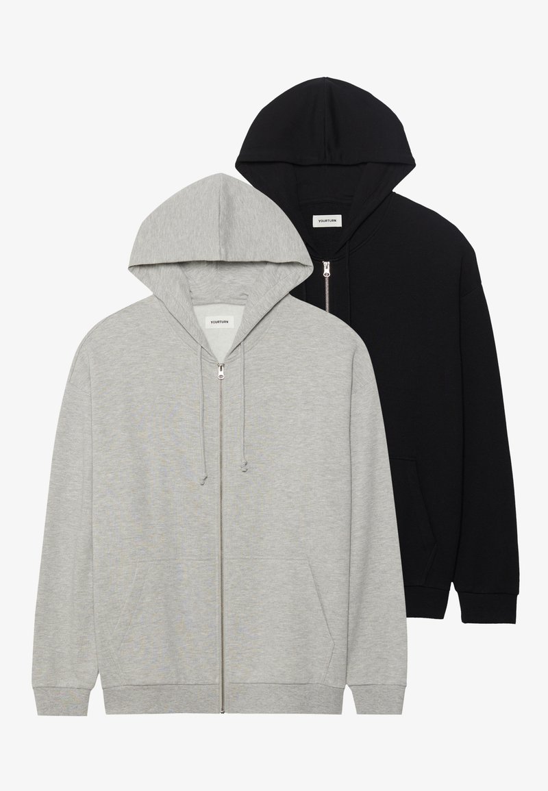 Zwei Kapuzenpullover: einer in Grau mit Reißverschluss und Kängurutaschen, der andere in Schwarz mit Reißverschluss, beide aus weichem Stoff.