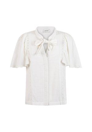 White blouse in lightweight fabric with short flared sleeves, a tie-neck detail, and eyelet accents along the placket and sleeves.