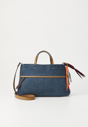 Dark blue bag made of fabric with brown leather accents. Features a top handle, adjustable shoulder strap, and decorative tassels.