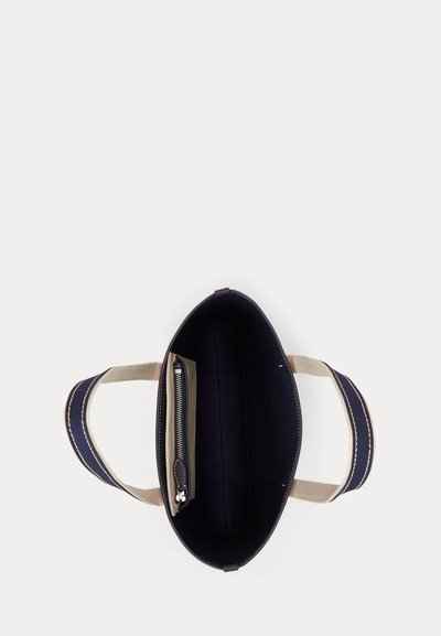 Open black tote bag with beige and navy handles, featuring an interior zippered pocket on one side.