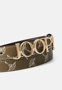 Green leather belt featuring white patterns and a gold-tone "JOOP!" buckle. The texture is smooth with raised accents along the edges.
