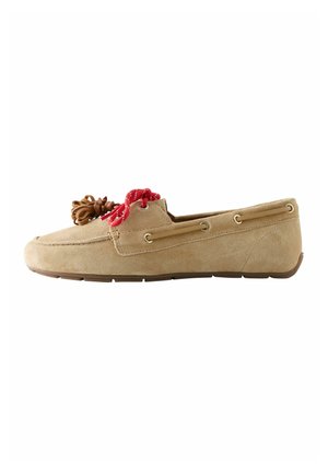 Tan suede loafer with red and brown decorative laces, moc toe stitching, and rubber sole, shown in side profile.