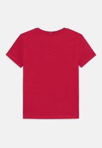 Rød bomulls t-skjorte med korte ermer, rund halslinje, og et enkelt design uten mønstre eller synlige detaljer.