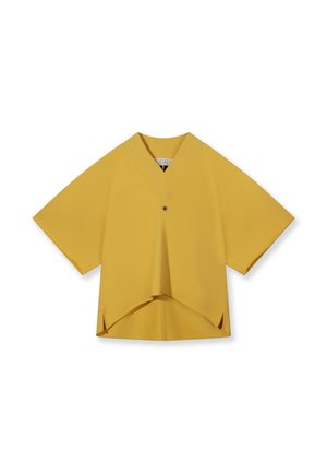 Yellow short-sleeve V-neck blouse with a single button, asymmetrical hem, and side slits on a white background.