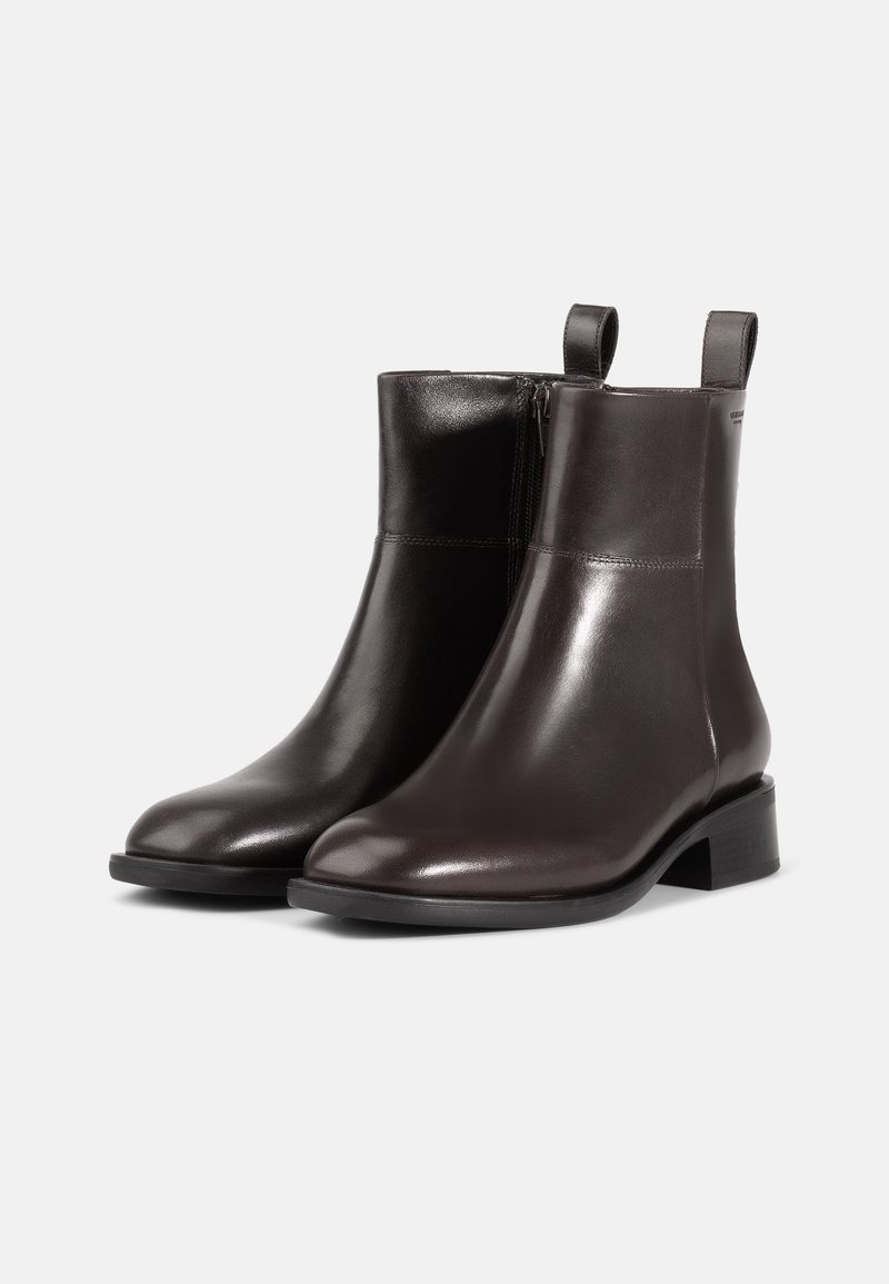 Brown leather ankle boots with a smooth finish, round toe, a side zipper, and dual pull tabs for easy wear. Low block heel.
