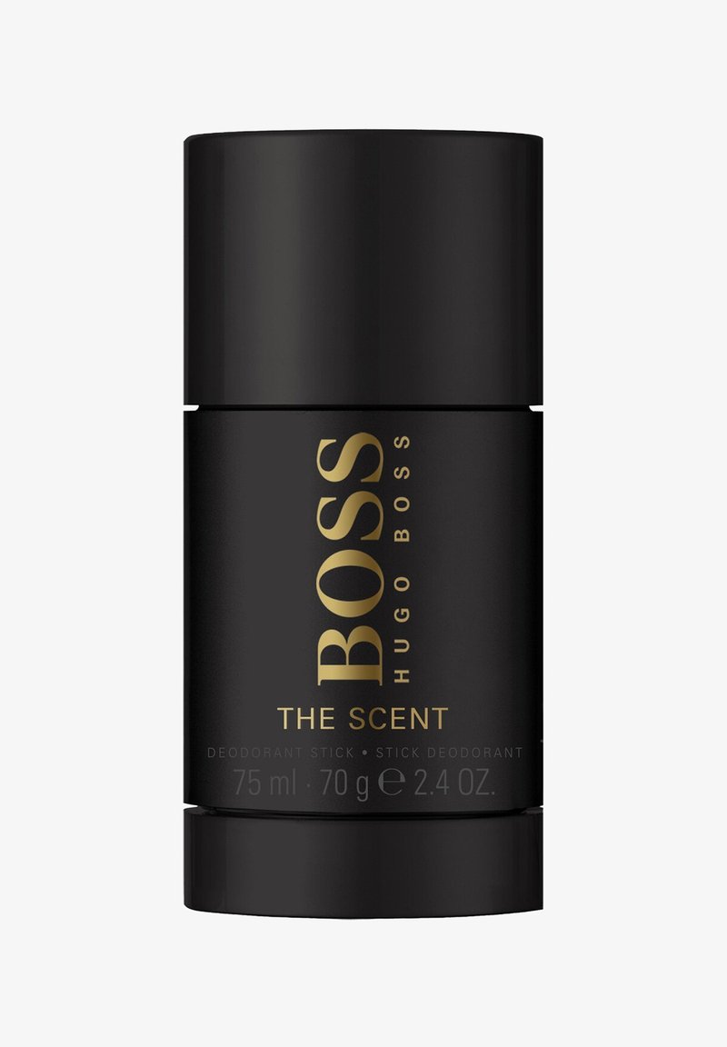 Hugo Boss The Scent Deodorantstick, schwarzer Behälter mit goldener Beschriftung, zylindrische Form, mit Produktdetails und Gewicht beschriftet.