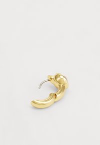 Gold-tone hoop earring with a curved design. Features a glossy finish, distinct rounded body, and a small attachment for closure.