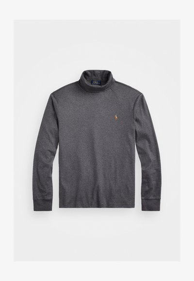 Σκούρο γκρι σουέτερ με ζιβάγκο κατασκευασμένο από μείγμα βαμβακιού. Διαθέτει μακριά μανίκια και μικρό κεντημένο λογότυπο στην αριστερή πλευρά του στήθους.