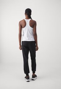 Casall COMFORT PANTS - Treniņtērpa apakšdaļas - black