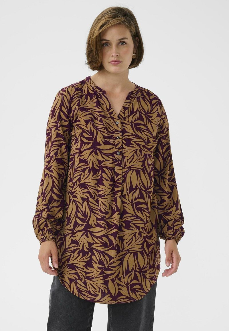 Blouse à manches longues bordeaux avec un motif de feuilles beige, dotée d'un col boutonné et de manches froncées. Tissu doux avec une coupe décontractée.
