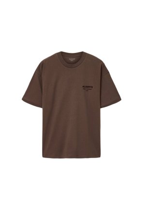 Bruine katoenen T-shirt met een ronde hals, korte mouwen en een zwarte logo-afdruk op de bovenste linkerzijde. Gladde textuur, ontspannen pasvorm.