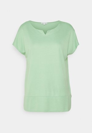 Blouse vert menthe à manches courtes avec encolure en V et large bande d'ourlet.