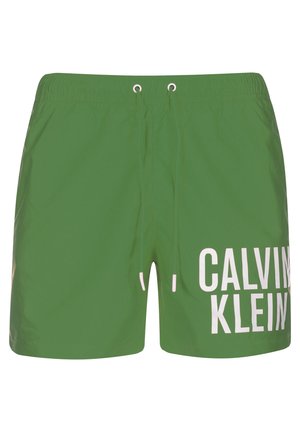 Bañador verde con cintura elástica, cordón y logo blanco "CALVIN KLEIN" en el lado izquierdo. Material suave y ligero.