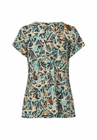 Kortärmad topp med ett turkos, svart och orange lövmönster på en beige bakgrund. Tillverkad av lätt och andningsbart tyg.