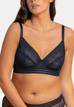 Bralette en dentelle marine avec une forme triangulaire, des bretelles réglables et un détail en nœud au centre. Présente un motif floral texturé.