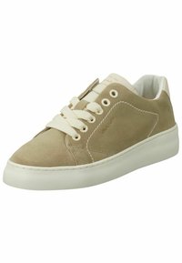 Suede light beige sneaker with white laces, rounded toe, and rubber sole. Features stitched accents and a branded label on the tongue.