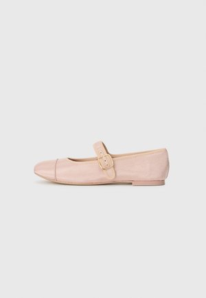 Pink ballet flat shoe with a rounded toe, vertical ribbed texture, side strap and buckle detail, featuring a low heel and smooth sole.