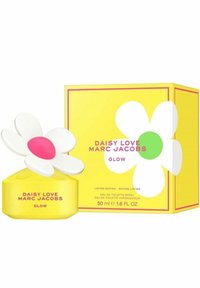 Gul glasparfymflaska med ett prästkrage-formad vitt lock och rosa mitt. Åtföljs av en färgglad, mönstrad låda med blommönster.