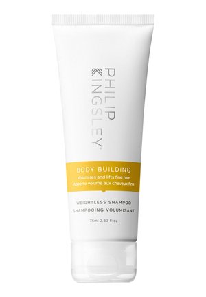Tube blanc de shampooing Body Building de Philip Kingsley avec des accents jaunes, 75 ml, présentant le nom de la marque et du produit en relief en argent.