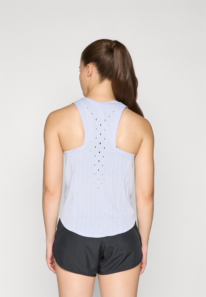 Lichtblauw sporttanktop met verticale strepen en circulaire perforaties; gecombineerd met zwarte shorts. Ontwerp aan de achterkant bevordert de luchtstroom.