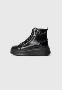 Black leather high-top sneaker boot with side zipper, lace-up front, studded detailing, and a thick platform sole.