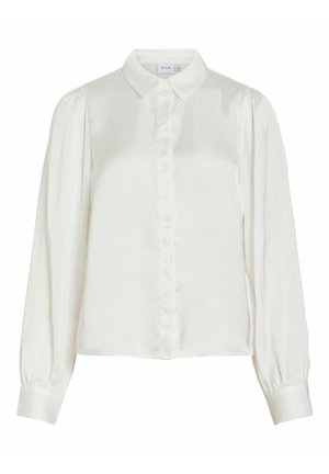 Bílá halenka s dlouhým rukávem, s špičatým límečkem, zapínáním na knoflíky vpředu, nařasenými rameny a širokými manžetami.