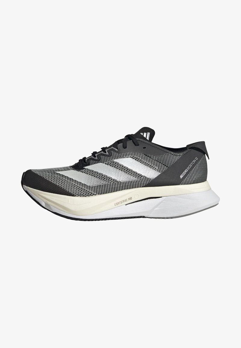 Black and white running shoe with a knitted upper, three side stripes, a lightweight sole, and textured detailing on the mesh.