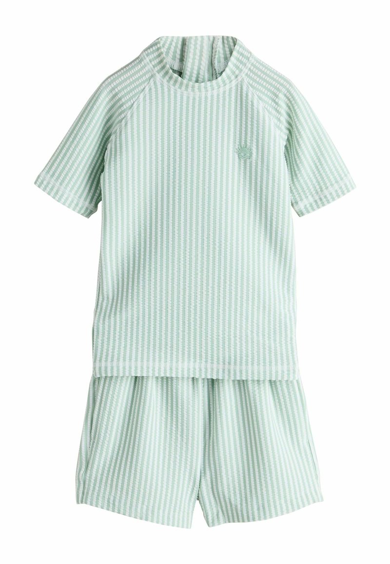 Světle zelené pruhované tričko s krátkým rukávem a odpovídající šortky. Vyrobeno z měkké látky, má kulatý límec a mírný elastick�ý materiál.