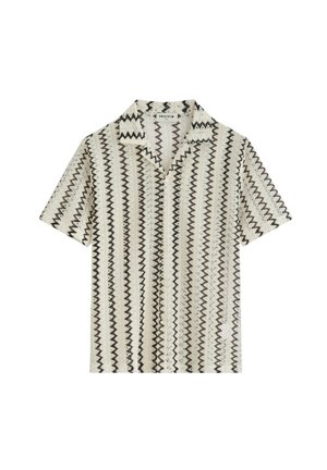 Chemise blanche à manches courtes avec des rayures verticales en zigzag noir et un large col, posée à plat sur un fond blanc.