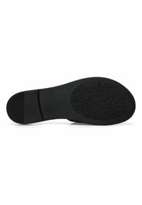 Sole di scarpa nera con superficie in gomma testurizzata, forma arrotondata e un accento liscio vicino al tallone. Presenta motivi antiscivolo per migliorare la trazione.