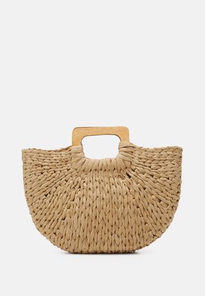 Half-circle woven straw handbag with a wooden rectangular handle in natural beige color on a white background.