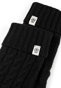 Black knitted fingerless gloves with ribbed cuffs, featuring cable knit texture and a woven label with graphic detail.