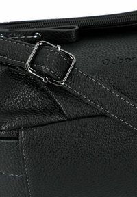 Borsa a mano in pelle nera con finitura a pietra, chiusura con zip e finitura testurizzata. Presenta il logo del marchio impresso sul lato.