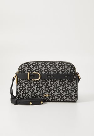Black and white crossbody bag featuring a repeating logo pattern, gold hardware, and a detachable strap. Smooth texture with a rounded shape.