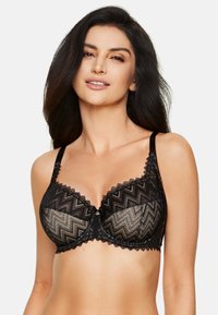 Czarny koronkowy biustonosz z wzorem w zygzak, przezroczyste miseczki z geometrycznym wzorem oraz ozdobnym elementem w centrum.