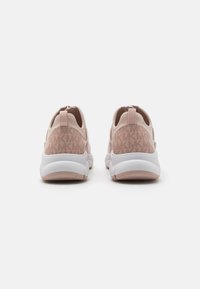 Pink athletic shoes with textured panels and a soft suede finish, featuring a chunky white sole and a pull tab on the heel for easy wear.