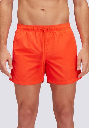 Costume da bagno arancione brillante realizzato in materiale leggero. Presenta una vita elasticizzata con cordino regolabile e una superficie liscia.