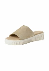 Beige suède slip-on sandaal met een open teen ontwerp en een dikke witte rubberen zool met geribbelde textuur voor grip.