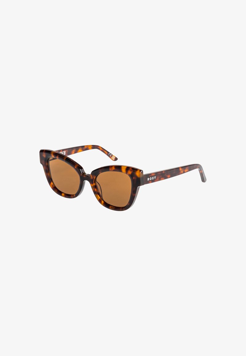 Tortoiseshell sunglasses with brown lenses. Cat-eye shape and thick frames. Roxy logo on the temple. Textured finish.