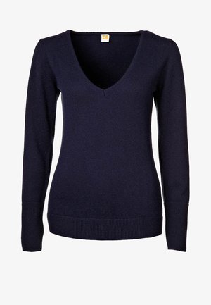 Marineblauwe V-hals trui met lange mouwen, geribbelde manchetten en zoom, met een klein rechthoekig label bij de halslijn.