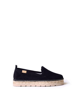 Black suede espadrille with a round toe, elastic side panels, and a jute rope midsole. Flat, textured rubber sole for grip and comfort.