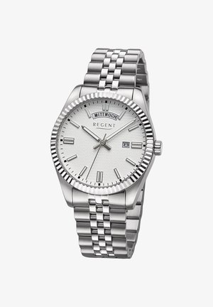 Montre en acier inoxydable argenté avec un cadran texturé blanc, affichage de la date et un bracelet en maillons métalliques. Caractéristiques : une lunette striée et des index en relief.