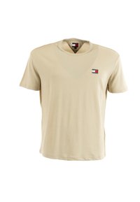 T-shirt in cotone beige con maniche corte e collo a giro. Presenta un piccolo logo multicolore sul lato sinistro del petto. Texture liscia.