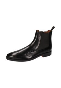 Schwarzer Leder-Ankle-Boot mit elastischen seitlichen Einsätzen, spitz zulaufender Zehenpartie und einer Ziehschlaufe an der Rückseite; glatte Textur und minimalistische Hardware-Detaillierung.
