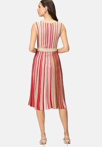 Knit dress with vertical red, pink, and gold stripes, featuring a fitted waist and flared skirt. Round neckline and sleeveless design.