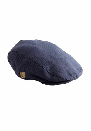 Navy blue cotton flat cap with a textured ribbed pattern, featuring a small square leather patch with a logo on the side.
