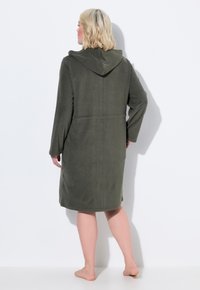 Olivově zelený kápi s dlouhými rukávy a délkou do poloviny lýtek, vyrobený z měkké, texturované látky a s uvolněným střihem.