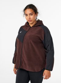 Brown fleece zip-up hoodie with black accents, featuring a hood, side pockets, and a smooth texture. Logo detail on the chest.