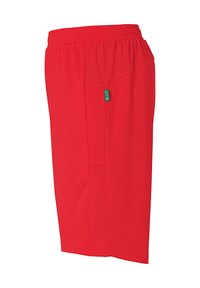 Red athletic shorts with a breathable mesh side panel, elastic waistband, and a side pocket featuring a small green tag.